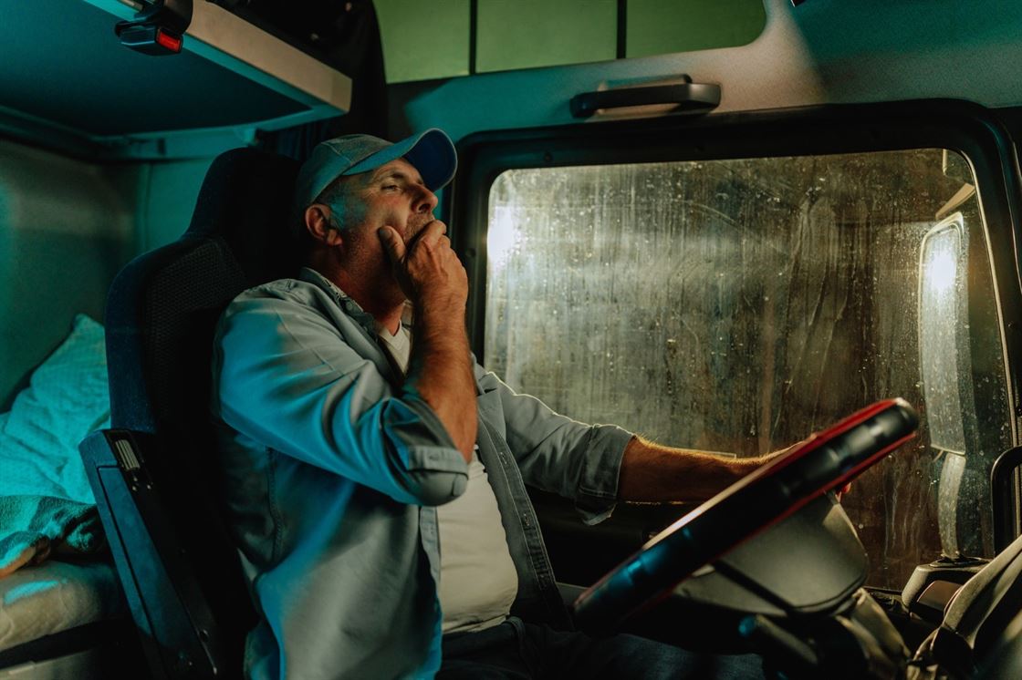 A person in a truck yawning

AI-generated content may be incorrect.